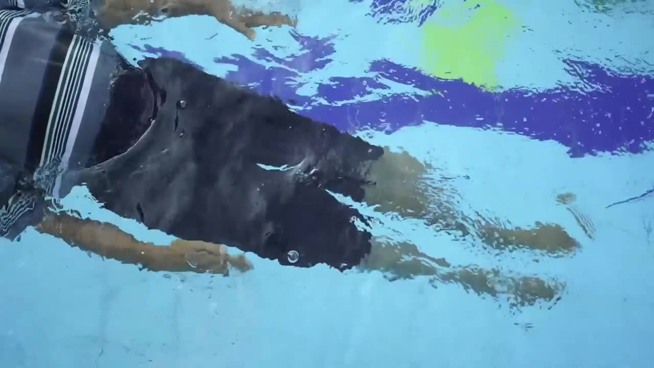 A resident swimming in the campus pool